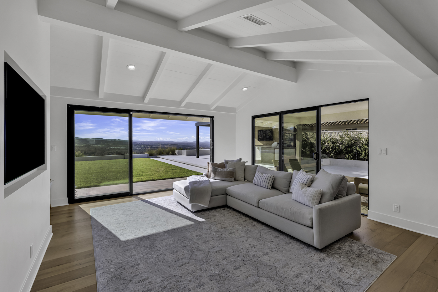 Equestrian Drive home renovation photo 4 — open-concept living and dining area after renovation